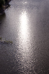 Image showing Background of ripple lake water and sun reflections.