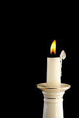 Image showing White burning candle in candlestick 