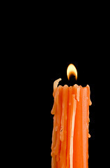 Image showing Burning orange candle 