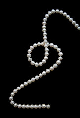 Image showing White pearls on the black velvet  background