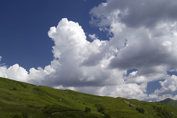 Image showing Green hill and blue sky with clouds