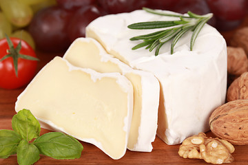 Image showing Still life with Camembert cheese cut on slices