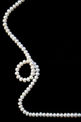 Image showing White pearls on the black silk background 