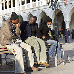 Image showing Tourists resting on a bench