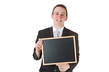 Image showing Businessman holding a blackboard