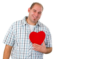 Image showing Young man holding red heart