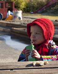 Image showing Child enjoying kindergarten lunch outdoors