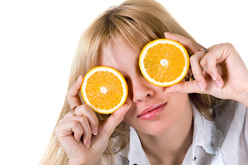 Image showing Portrait of the funny girl with oranges. Isolated on white