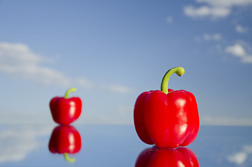 Image showing Paprika stand on mirrow in background of blue sky.