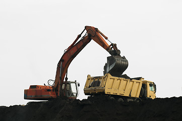 Image showing Excavator loading truck