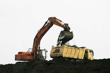 Image showing Excavator loading truck