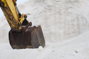 Image showing Excavator digging pile salt