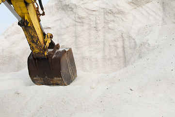 Image showing Excavator digging pile salt