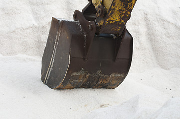 Image showing Excavator digging pile salt