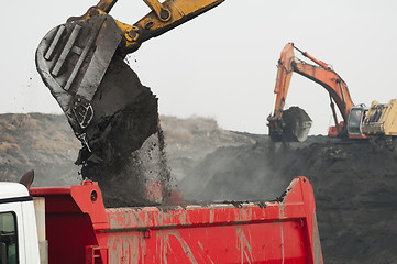 Image showing Excavator loading truck