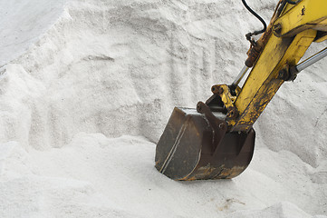 Image showing Excavator digging pile salt