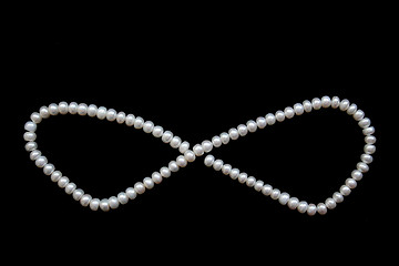 Image showing White pearls on the black silk 