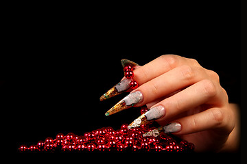 Image showing Human fingers with long fingernail and beautiful manicure isolated on black