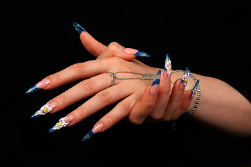 Image showing Human fingers with long fingernail and beautiful manicure isolated on black