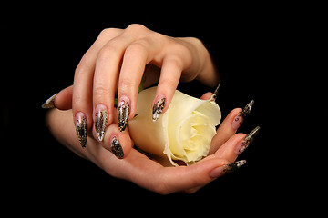 Image showing Human fingers with long fingernail and beautiful manicure isolated on black