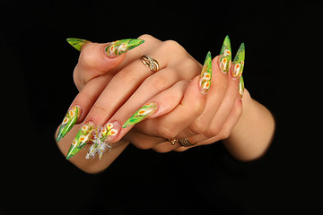 Image showing Human fingers with long fingernail and beautiful manicure isolated on black