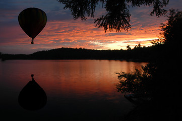 Image showing Hot-Air Balloon over Lake at Sunset Sunrise