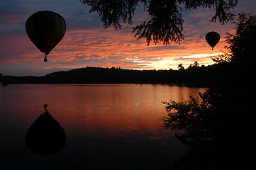 Image showing Hot-Air Balloons over Lake at Sunset Sunrise