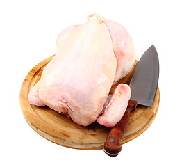 Image showing Uncooked chicken on a cutting board.