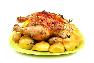 Image showing Chicken stuffed with lemons, apples and rosemary.