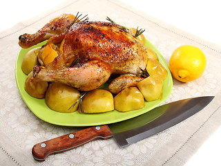 Image showing Chicken stuffed with lemons, apples and rosemary.