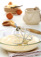 Image showing Vanilny sauce in a bowl and whisk for whipping.