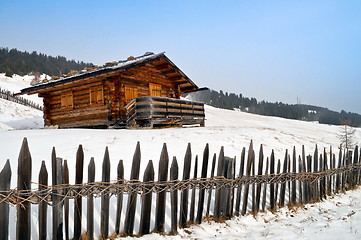 Image showing Old winter cottage with fence