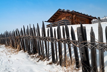 Image showing Old winter cottage with fence