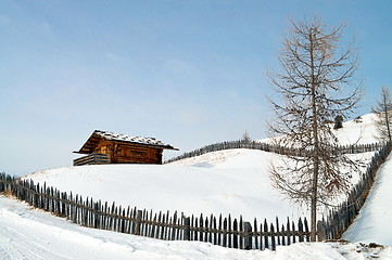 Image showing Old winter cottage with fence