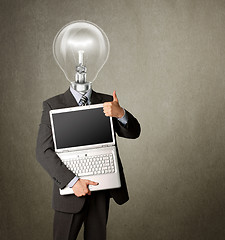 Image showing businessman with lamp-head with open laptop shows welldone