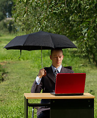 Image showing businessman with umbrella