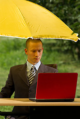 Image showing businessman with umbrella