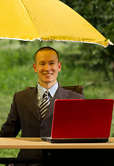 Image showing businessman with umbrella