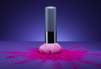 Image showing makeup brush and face powder scattered