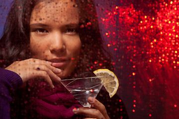Image showing Attractive Asian woman with drink in cold rainy weather