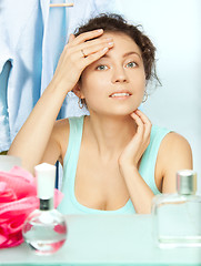 Image showing Woman inspecting skin for spots