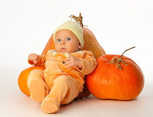 Image showing Baby with pumpkins