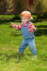 Image showing Toddler make first steps in the garden