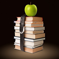 Image showing books pile with belt and apple