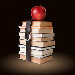 Image showing books pile with belt and apple