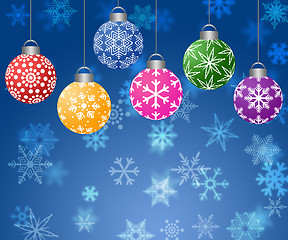 Image showing Hanging Ornaments on Blurred Snowflakes Background Horizontal