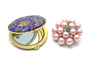 Image showing  cosmetic mirror and brooch