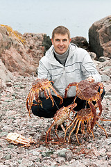 Image showing man with crabs in the Barents Sea coast