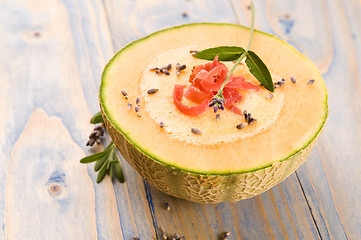 Image showing fresh melon soup with parma ham and lavender flower