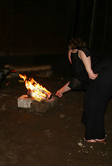 Image showing lighting a sparkler on the bonfire